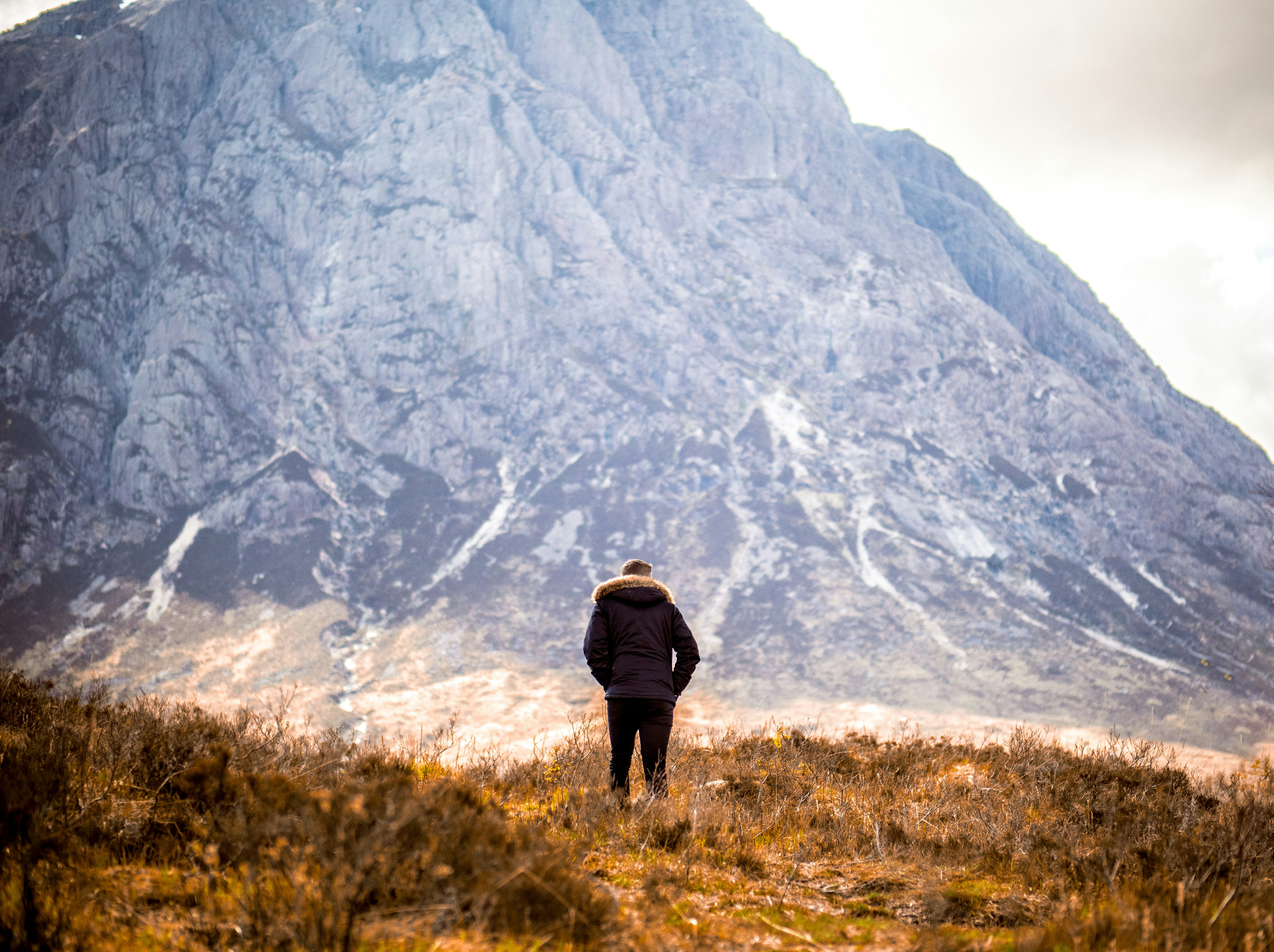 man standing in front of mountain
